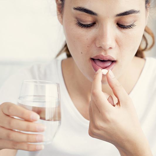 Woman taking pain pill