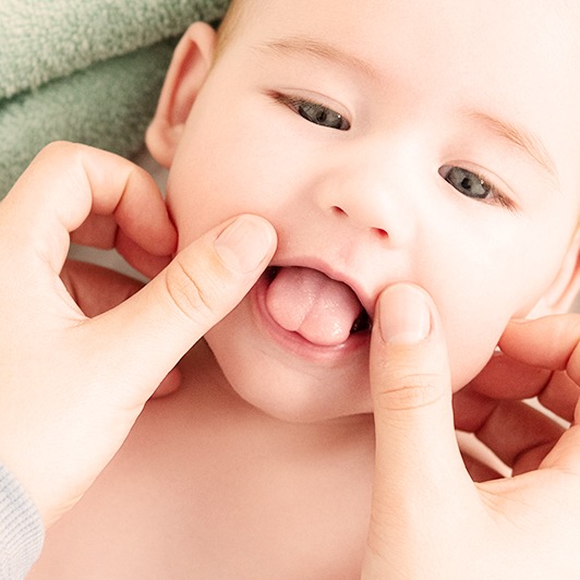 Dentist checking baby's frenum