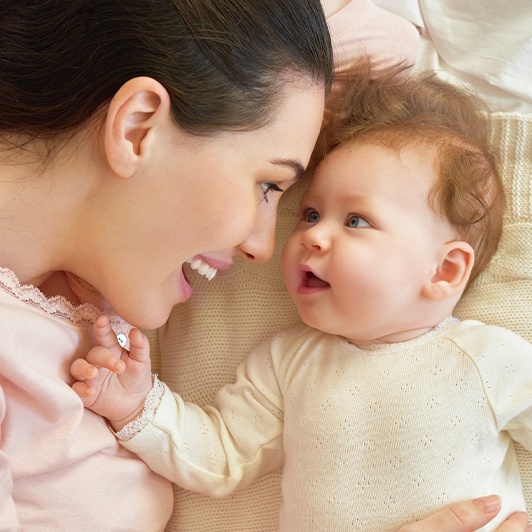 Mother smiling about baby who has tethered oral tissues