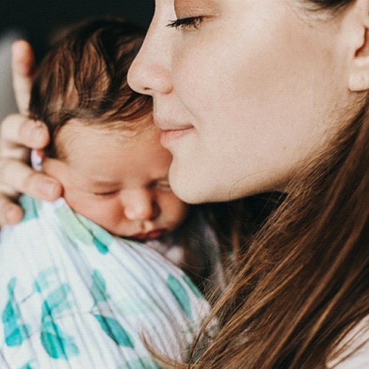 A mother holding her newborn baby close in Phillipsburg