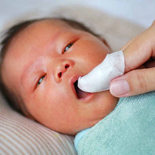 Parent performing stretches after frenectomy in Phillipsburg