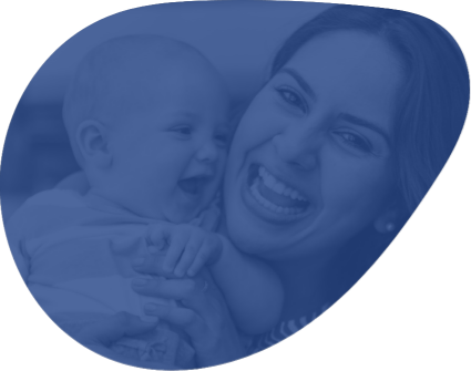 Mother holding laughing baby after lip and tongue tie