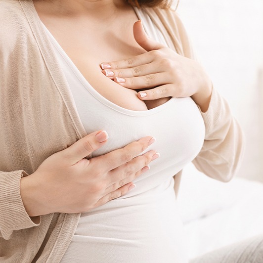 Woman experiencing pain and struggling to breastfeed