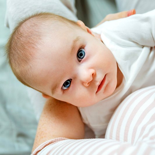 Baby looking up at mother