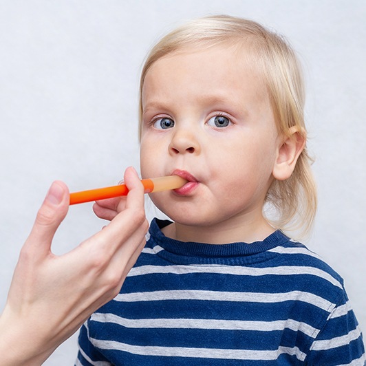 Dentist checking child's mouth function