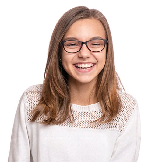 A female teenager wearing a white sweater and smiling in Phillipsburg