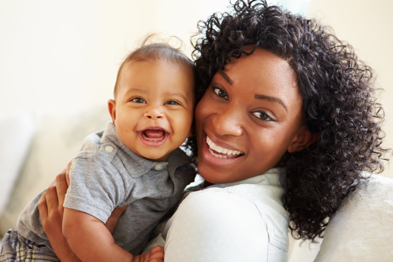 a mother and her baby smiling and happy