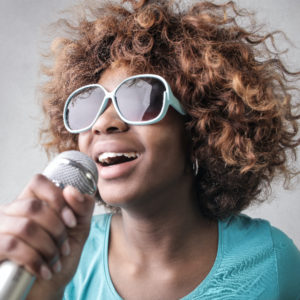 Woman singing into microphone