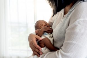 parent about to check the baby for a lip or tongue tie