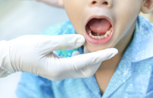 a smiling child visiting their dentist 