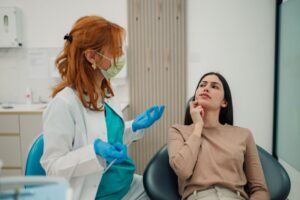 Concerned dental patient talking with her dentist