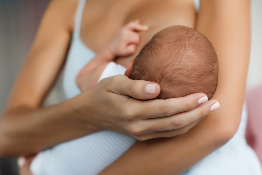 A mother breastfeeding a baby